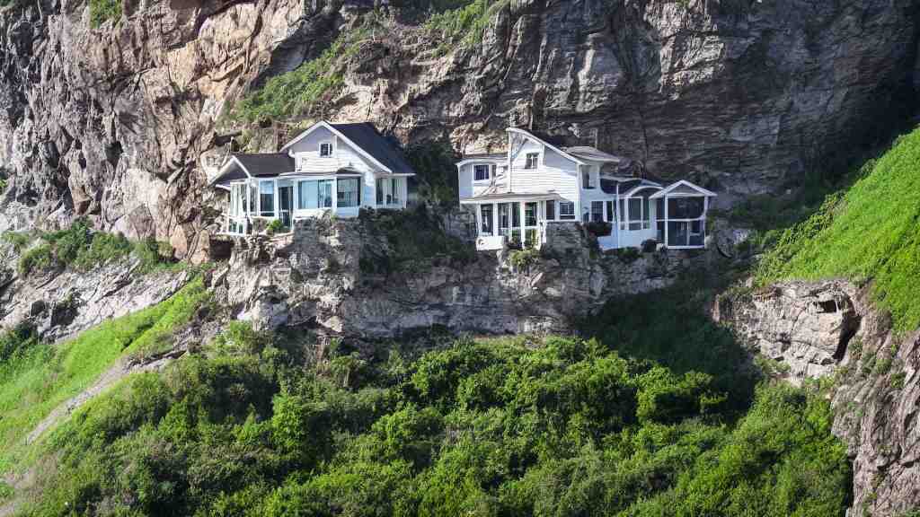 house built on the side of a cliff, award winning photo